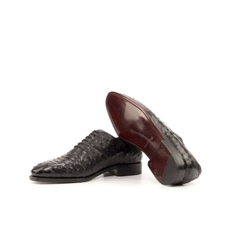 Black ostrich leather whole-cut oxford shoes with a smooth brown leather sole, handmade in Spain.