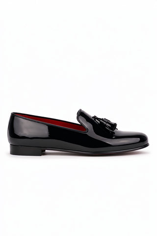 Black patent calfskin leather tassel loafer with a red leather interior and outsole.