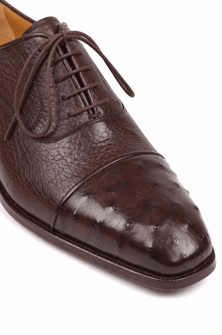 Paul Parkman brown ostrich and calfskin leather oxford shoe with a round toe and lace-up design.