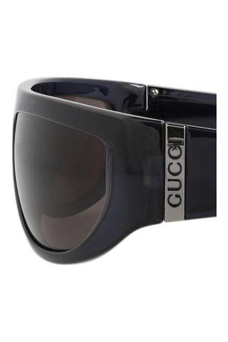 Gucci shield sunglasses in shiny transparent cobalt blue injection frame with silver logo temple detail.