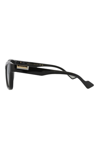 Side view of Gucci GG1621 men's shiny black square injection sunglasses with gold logo temple detailing.