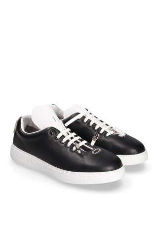 Black leather T-Switch sneakers with white soles, laces, and a unique interchangeable tongue system.