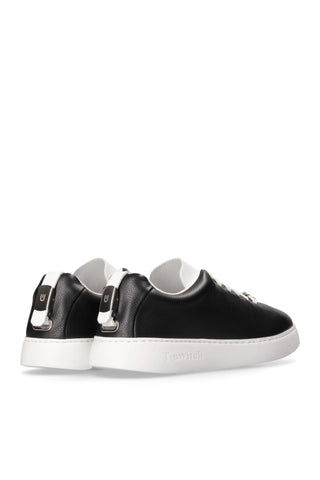 Black leather T-Switch sneakers with white soles and a unique interchangeable tongue system for a versatile look.
